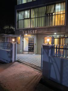 a building with a gate in front of it at night at Hotel Swagat Residency in Panhāla