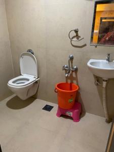 a bathroom with a toilet and a sink at Hotel Swagat Residency in Panhāla