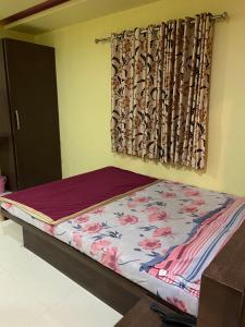 a bed in a room with a curtain at Hotel Swagat Residency in Panhāla