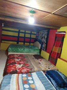 a bedroom with two beds in a room at Askara Toba Cottage in Tuktuk Siadong