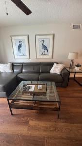 a living room with a couch and a glass coffee table at Fully Updated, Ground Floor, Poolside With Great Ocean View - Unit 49! in Cocoa Beach +20 photos