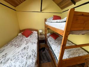 a bedroom with two bunk beds and a lamp at Patate Heights in Hacienda El Carmen