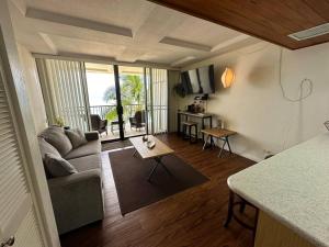 a living room with a couch and a table at 305 On the Beach in Waianae
