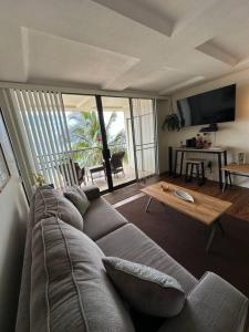 a living room with a couch and a table at 305 On the Beach in Waianae