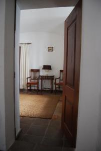 an open door to a room with a table and chairs at Casa da Muralha de Serpa in Serpa
