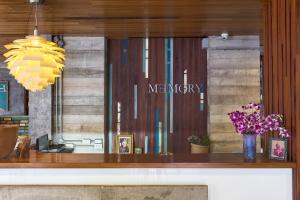 a store window with a mercury sign and flowers at Memory Patong - SHA Certified in Patong Beach