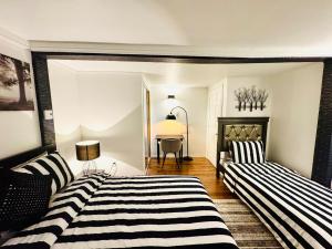 a bedroom with two beds and a table in the background at Linda inn - Entire Unit- Sleep 3- Sherbrooke in Sherbrooke