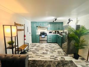 a kitchen with green cabinets and a tile floor at Linda inn - Entire Unit- Sleep 3- Sherbrooke in Sherbrooke