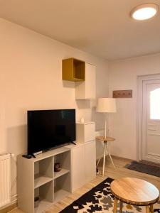 a living room with a flat screen tv on a white cabinet at Transylvanian Nomad II in Cluj-Napoca