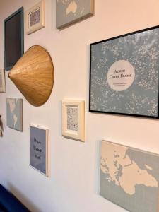 a wall with pictures and a flat screen tv at Transylvanian Nomad II in Cluj-Napoca