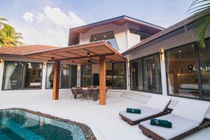 a villa with a swimming pool and a house at NOBELLA Villa, Luxury Boutique Hotel in Ko Phangan