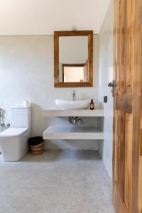 a bathroom with a sink and a mirror at Beach House by Unrushed in Welhengoda