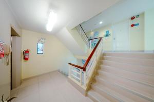 a hallway of a hospital with stairs and a fire extinguisher at Salin Home Hotel Ramkhamhaeng in Bangkok +51 photos