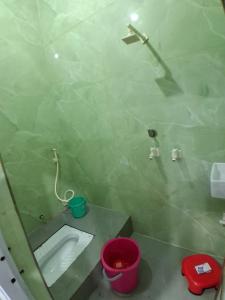 a small bathroom with a toilet and a mirror at JSRInn in Mathura +1 photo