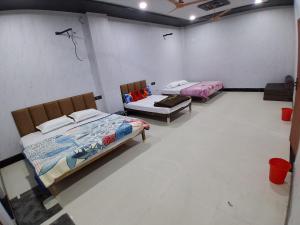 two beds in a room with a room with two at JSRInn in Mathura