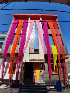 a building with colorful flags on the front of it at JSRInn in Mathura