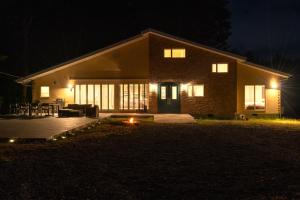 a house at night with a fire in front of it at A-PLAZA Yamanakako in Yamanakako
