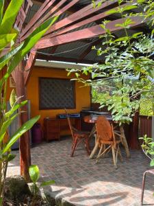 a patio with chairs and a table and a screen at Cabinas Cable Talamanca in Puerto Viejo