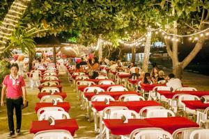 a row of red and white tables and chairs at Phi Phi Banyan Villa in Phi Phi Islands +91 photos