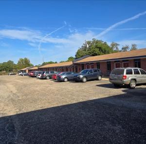 a row of cars parked in front of a building at Candle Light Motel in Ozark