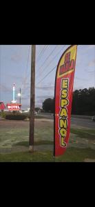 a sign for a fast food restaurant next to a pole at Candle Light Motel in Ozark