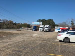 a parking lot with a bunch of trucks parked at Candle Light Motel in Ozark