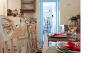 a dining room with a table with a glass of wine at Apartment Alloga in Belgrade