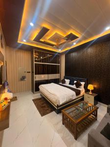 a bedroom with a bed and a couch and a table at Hotel Riverviewinn in Varanasi