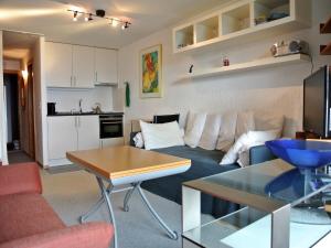 a living room with a couch and a table at Panorama in Villars-sur-Ollon