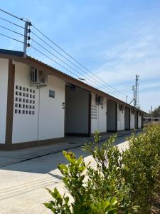 a row of buildings with white doors on them at เดย์ อิน in Ban Nong Sua Chang