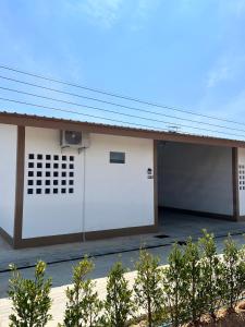 a building with two white garage doors at เดย์ อิน in Ban Nong Sua Chang +3 photos
