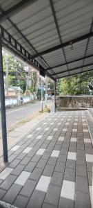 an empty parking lot with a covering on a street at Krishna stays in Manattala +3 photos