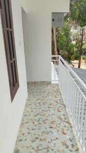 a hallway with a tile floor and a door at Krishna stays in Manattala