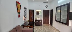 a living room with a couch and a mirror at Krishna stays in Manattala