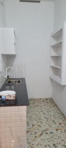 a kitchen with a sink and a counter top at Krishna stays in Manattala