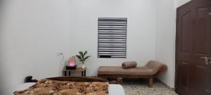 a living room with a chair and a window at Krishna stays in Manattala