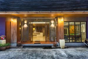 a front entrance to a home with glass doors at Memory Patong - SHA Certified in Patong Beach