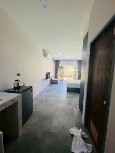 a room with a kitchen and a bedroom with a bed at Blue Mountain Kamala Phuket in Kamala Beach +4 photos