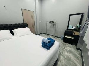 a bedroom with a bed with a blue bag on it at SRE- JOY Holiday Home in Mae Sot in Mae Sot