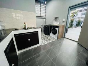a kitchen with a dishwasher and a washing machine in it at SRE- JOY Holiday Home in Mae Sot in Mae Sot