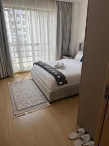 a bedroom with a bed and a large window at Zen Haven Lavington in Nairobi +18 photos