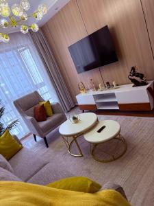 a living room with a couch and a tv at Zen Haven Lavington in Nairobi