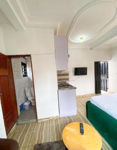 a small room with a bed and a table at Abu Dhabi CC Hotel in Limbe