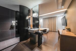 a bathroom with a sink and a bed at Hotel Hills in Paju