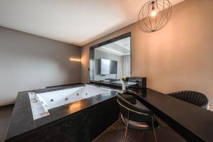 a bathroom with a large tub with a window at Hotel Hills in Paju +61 photos