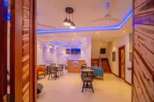 a hallway with a dining room with blue lights at Vilu Himmafushi in Himmafushi