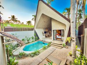 a house with a swimming pool in the backyard at Diwatu Villas in El Nido