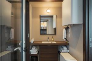 a bathroom with a sink and a mirror at JR Mobile Inn Hakodate in Hakodate +45 photos