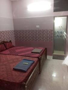 a bedroom with a bed and a bathroom with a shower at Jacobs Cottage KG-F2 in Thiruchendur