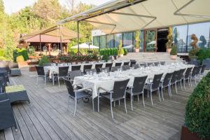 a row of tables and chairs on a deck at Hotel Diesel in Bucharest